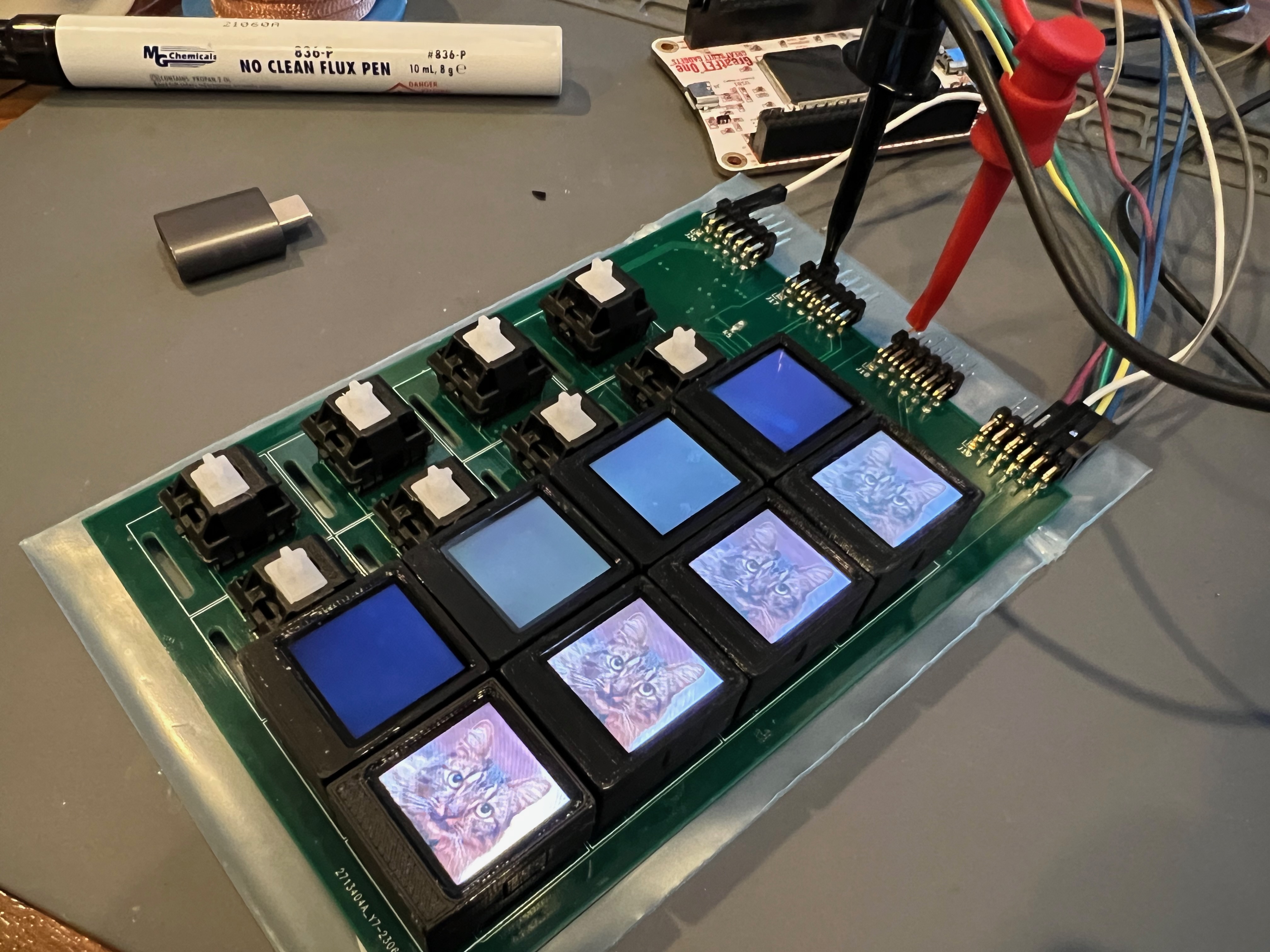 ButtonSlab with backlight turned on for one column, hooked up to GreatFET One for testing a single LCD cluster; jumper wires visible on one PMOD and power connected to another one