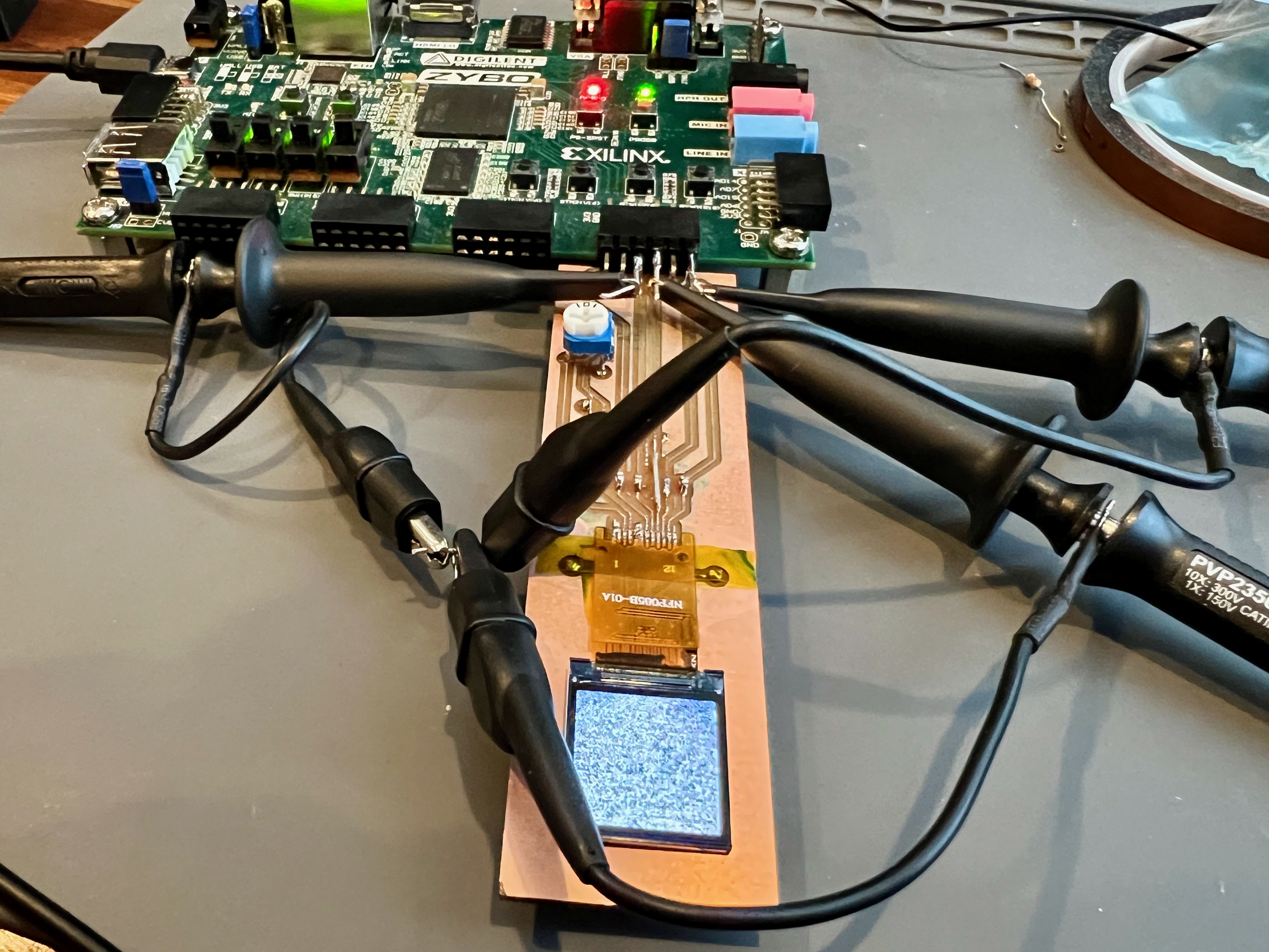 LCD on test PCB connected to a Digilent Zybo FPGA board (Zynq) with oscilloscope probes on the SPI lines